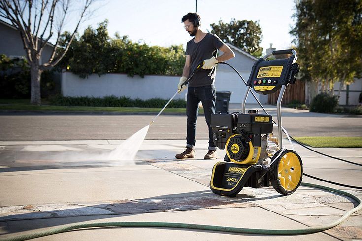 Gold Coast pressure washing technician using specialized equipment to clean commercial property.